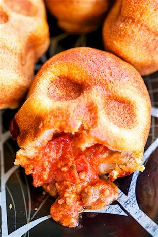 Pizza Skulls - pizza pockets baked in a skull pan. SO easy!! Can customize each pizza pocket to everyone's preference. Great for Halloween and The Walking Dead parties! Can bake and freeze for later!